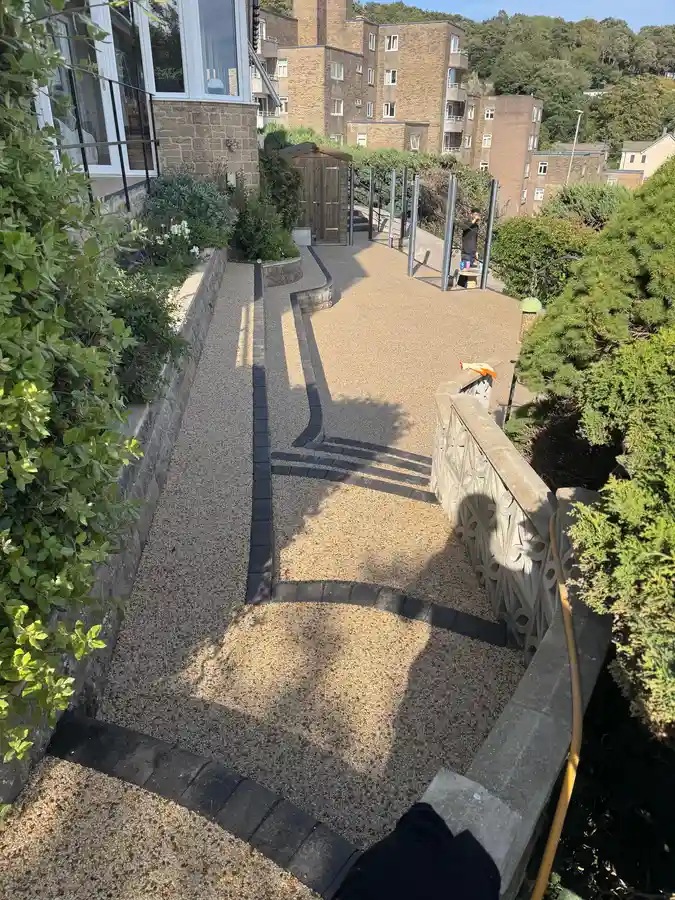 Buff resin bound garden pathway winding through a coastal Bournemouth garden