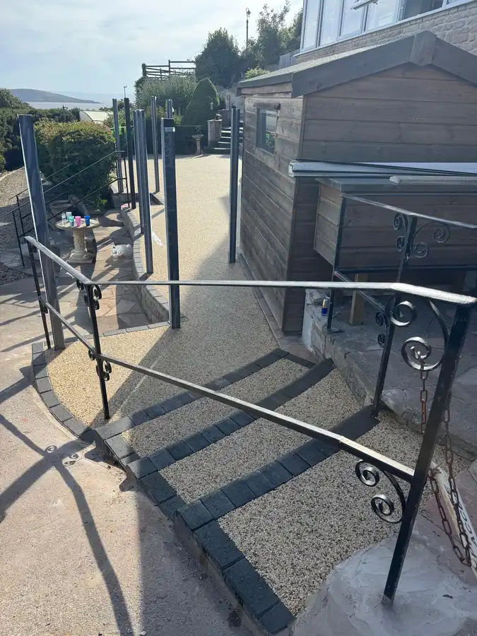 Buff resin bound pathway and steps with a coastal view in Bournemouth