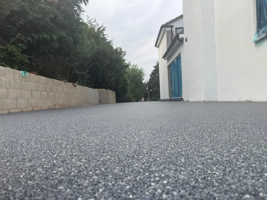 Grey resin bound driveway surface on a sloped Bournemouth plot