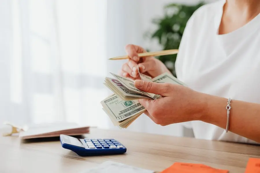 A calculator and budgeting, weighing up the cost difference between the two surfaces