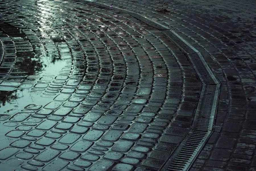 Rainwater draining on a driveway surface, the key practical split between the two systems