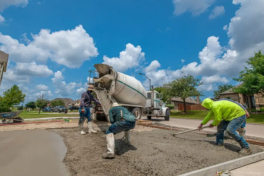 Resin bound surfacing being hand-trowelled onto a prepared base