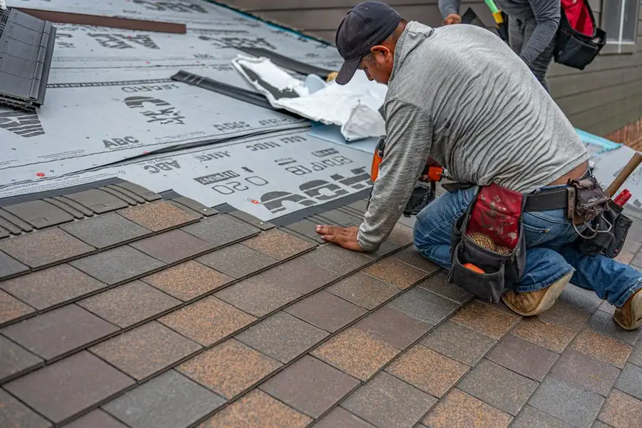 Workmen laying a surface - the quality of the base preparation beneath what you see is what determines long-term performance