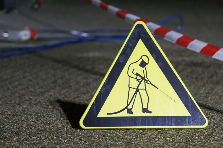 A pressure washer cleaning an outdoor surface