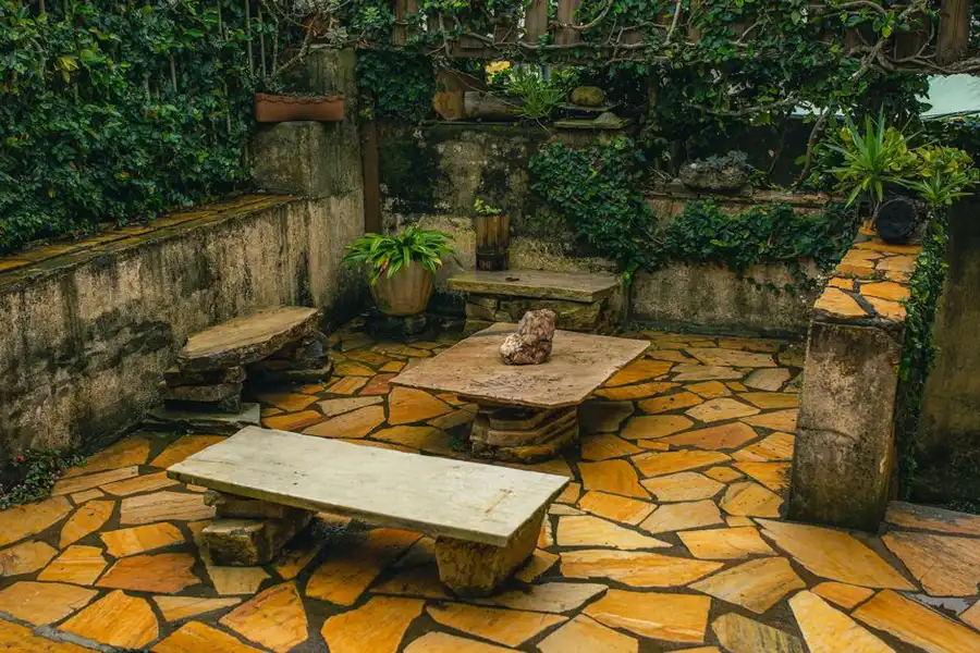 A paved garden patio area before conversion - the condition of the existing surface is the biggest factor in what a resin patio costs