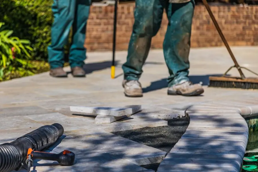 Installers laying a resin bound driveway surface