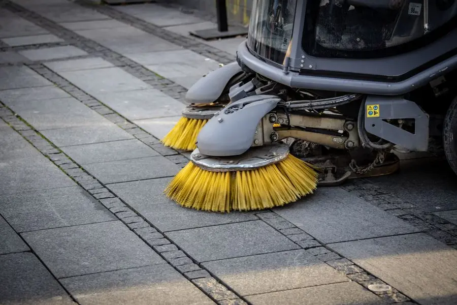 A well-maintained resin driveway being swept
