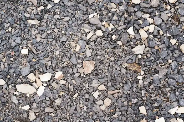 Loose gravel stones on a driveway, the surface resin improves on