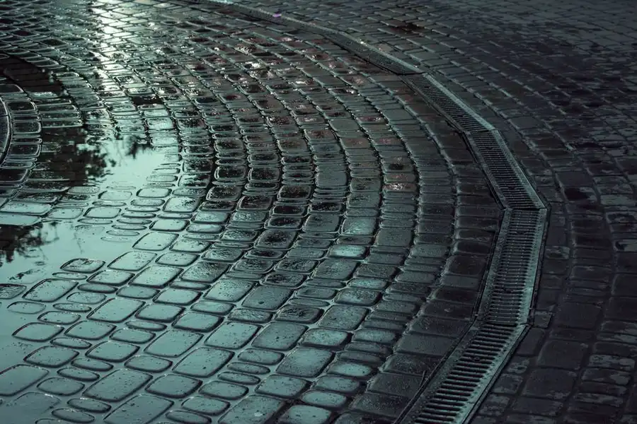 Water pooling on a driveway surface - drainage behaviour is one of the key practical differences between resin and tarmac