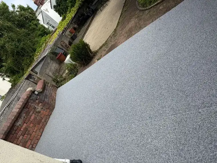 A charcoal resin bound driveway at a Bournemouth home, weighing up whether resin is worth the cost